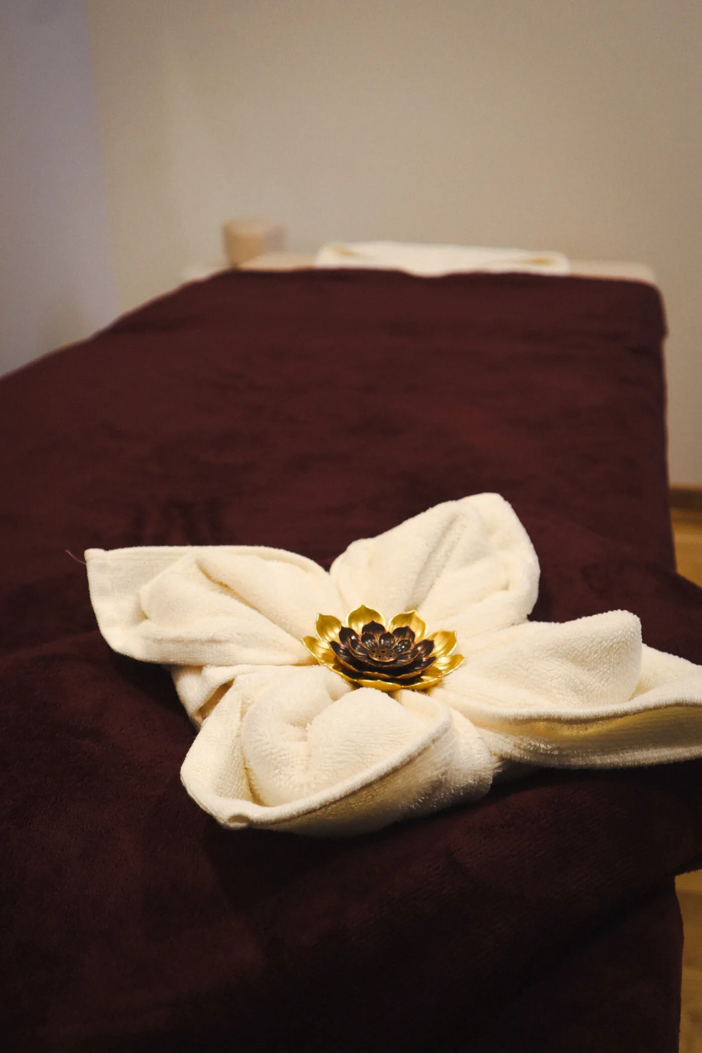 Serviette pliée en fleur sur la table de massage
